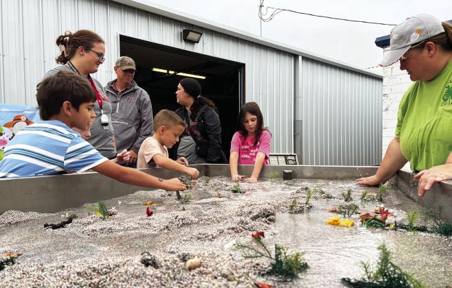 Kids Day at the 2025 Garvin County Free Fair Aug. 29 was all about hands-on learning. Here area school children learn how water flows over and around different types of terrain. 