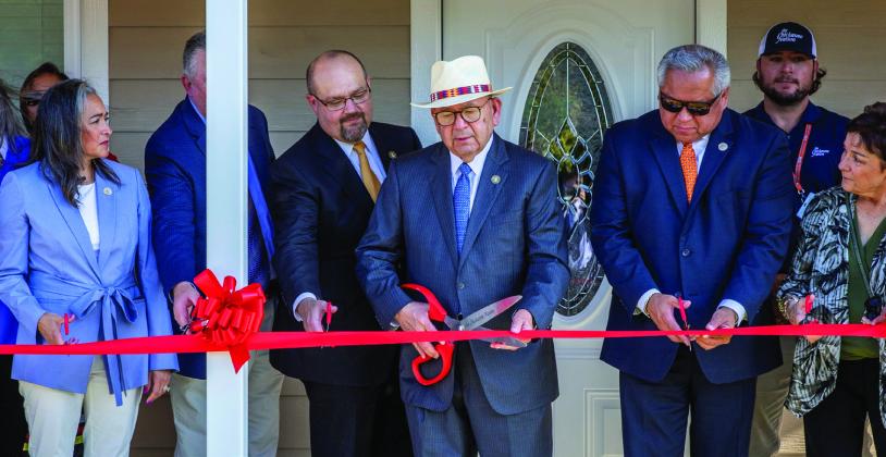 Chickasaw Nation Governor Bill Anoatubby, center, is joined by Chickasaw Nation Lt. Governor Chris Anoatubby, Chickasaw veterans and tribal, federal and local dignitaries in ribbon cutting ceremonies to dedicate the Tashka Inchokka' neighborhood, Aug. 14 in Ada. The housing community is designed for Chickasaw veterans.