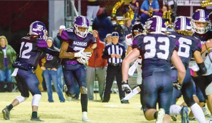 Badger Caleby Lauderdale hands the ball to Damontre Patterson during the quarterfinal playoff loss to Pawhuska last Friday night. Photo by Kristy Schrader