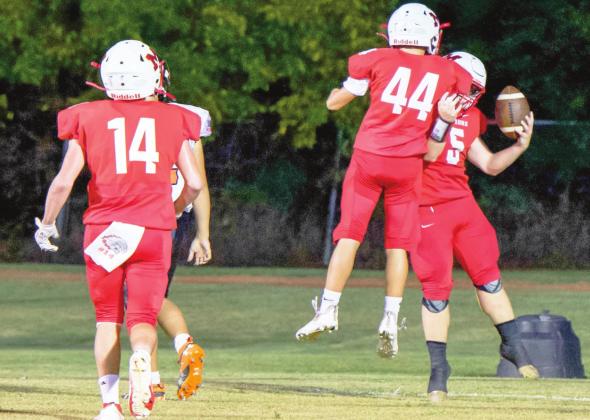 Bryce Shannon and Holden Tyler celebrate Nigel Reid's touchdown against Ryan last Thursday night. Photo by Kristy Schrader