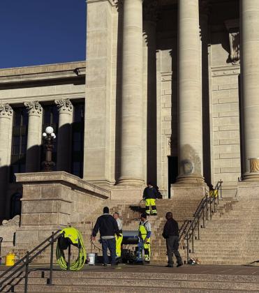 Cleaning crews work to remove graffiti from the south side of the Oklahoma Capitol building on Jan. 13, 2026. (Photo by Emma Murphy/Oklahoma Voice)