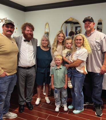 Megan Gregg (second from right) with her family during a retirement reception in her honor last Friday at the Garvin County Courthouse. Gregg is retiring from a 23-year career in the Garvin County District Attorney’s office. News Star photo by Suzanne Mackey