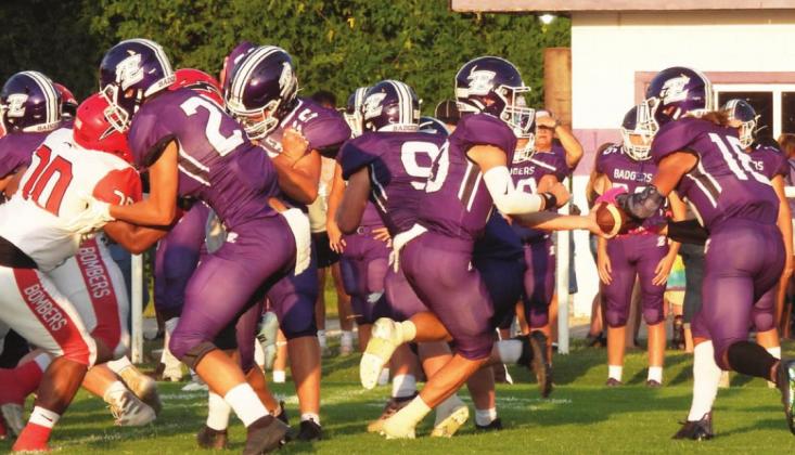 #10 Tyler Martin hands the ball to #16 Derrion Rogers against Frederick. Photo by Chris Mackey