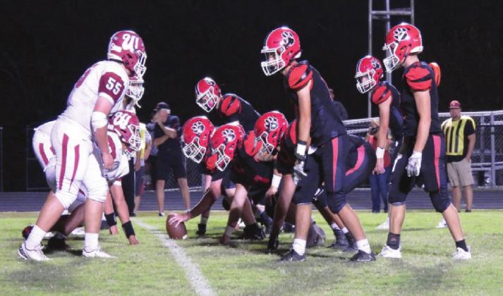 The Savages' defense tries to stop the Bulldogs from scoring. Photo by Chris Mackey