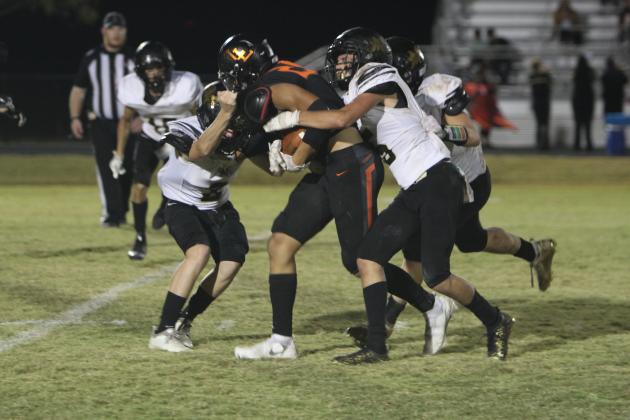 It took three players plus another on the way to stop Lindsay Leopard #25 Seth Padilla, but not before he got first-down yardage in last Thursday's game with Marietta. Photo courtesy of Sheryl Kochert. 