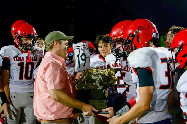 Jason Bridwell presents the "Battle on 19" trophy to the Pauls Valley Panthers after their 21-12 win over Lindsay last week.  News Star photo by Kristy Schrader