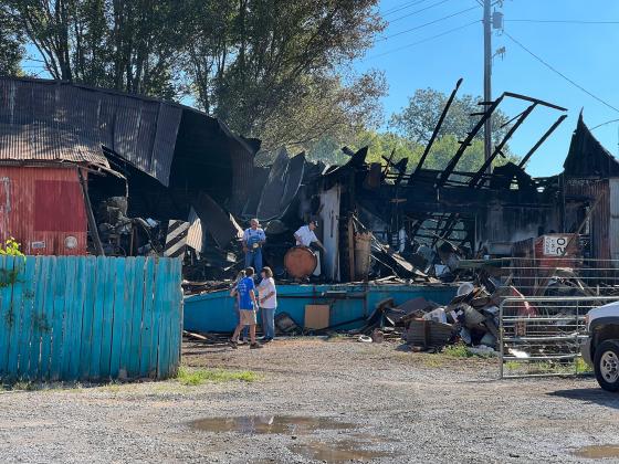 Family and friends of Swap Shop owners Pat Childress and Sherry Frazier showed up early Monday morning to help clean up fire damage. Two warehouse buildings adjacent to the resale shop’s main building were destroyed in Sunday’s fire. News Star photo by Suzanne Mackey