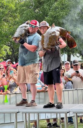 Sammy Cooper Jr. (left), of Duncan, won the top prize of Biggest Fish at the 2023 Okie Noodling Tournament Saturday, with a 68.9-pound catfish. Dakota Widuk (right) won third place in the Natural Division with a fish weight of 59.98 pounds. News Star photo by Suzanne Mackey