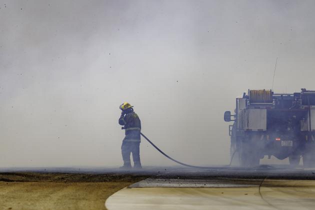 A firefighter works to extinguish a raging wildfire on the west side of Stillwater in early March 2025. (Photo by Mitchell Alcala, OSU Agriculture)