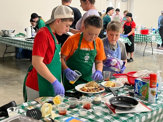 Maysville 4-H members (l-r) Lawson Thompson, Case Baker and Jaxon Thompson put the finishing touches on their competition plate during the Garvin County 4-H Food Showdown contest April 8. News Star photo by Suzanne Mackey