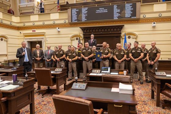 Sen. Casey Murdock, R-Felt, recognizes Trooper Cody Creswell, who is surrounded by his Oklahoma Highway Patrol colleagues on the floor of the Senate. Courtesy Photo