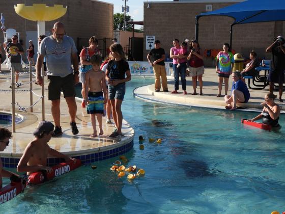 Contestants follow their ducks through the race course as lifeguards stand by to keep the ducks on track during the Pauls Valley Waterpark’s Duck Derby July 25. News Star photo by Chris Mackey