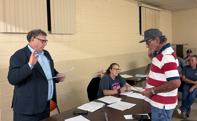 Joe Forkner (right) takes his oath of office after being appointed to fill one of two vacancies on Maysville's Town Board Trustees during a special meeting of the board Sept. 30. Photo courtesy of Joy Taylor 