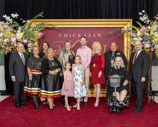 Chickasaw Nation Governor Bill Anoatubby, left, and Lt. Governor Chris Anoatubby, right, with 2025 Chickasaw Hall of Fame inductees and their families. From left: Gina Brown, Lisa John, LaDonna Brown, Susan Woods, Molly Hansen, Brooke Hansen, Michael Hansen, Tobi Merritt Edwards Young, Michael Keith Crossley and ‘Rena Bell Duncan.