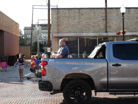 Pauls Valley Police Officer Sterling Redden tosses water balloons at the crowd. News Star photo by Chris Mackey