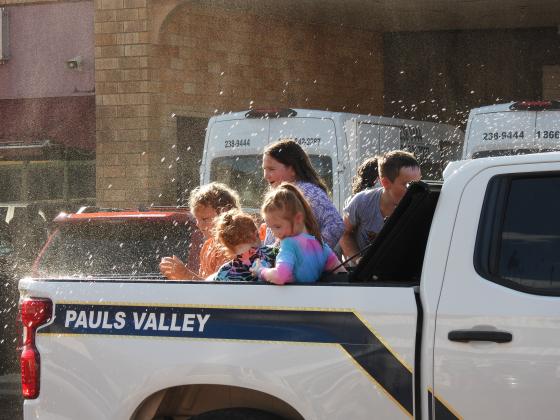 Parade participants throw water balloons at the crowd during Monday's Water Fight Parade. News Star Photo by Chris Mackey.