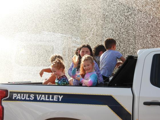 Parade participants throw water balloons at the crowd during Monday's Water Fight Parade. News Star Photo by Chris Mackey.