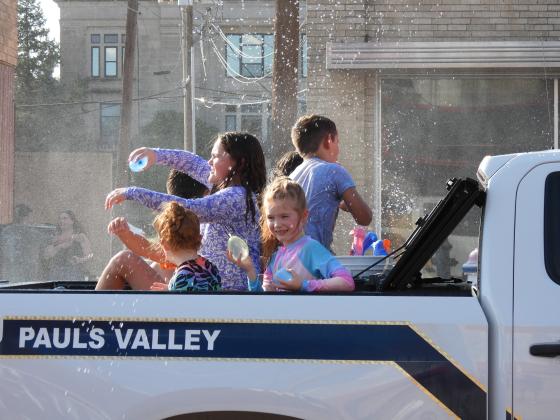 Parade participants throw water balloons at the crowd during Monday's Water Fight Parade. News Star Photo by Chris Mackey.