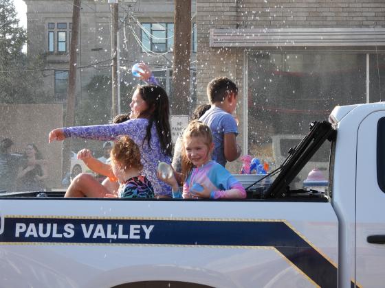 Parade participants throw water balloons at the crowd during Monday's Water Fight Parade. News Star Photo by Chris Mackey.
