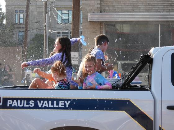 Parade participants throw water balloons at the crowd during Monday's Water Fight Parade. News Star Photo by Chris Mackey.