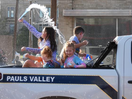 Parade participants throw water balloons at the crowd during Monday's Water Fight Parade. News Star Photo by Chris Mackey.