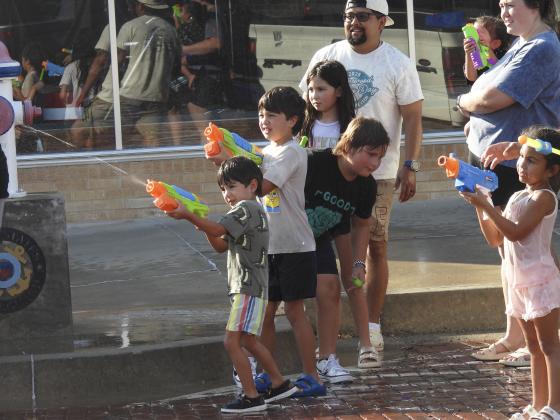 Kids take aim during Monday's Water Fight Parade.News Star Photo by Chris Mackey.