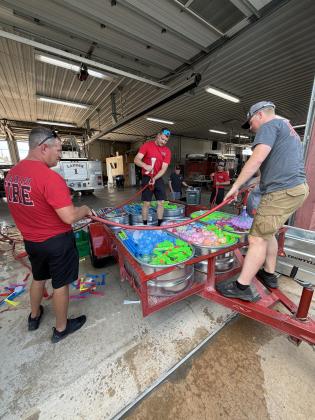 Pauls Valley fire and police departments helped fill and distribute water balloon and blaster stations along Paul Avenue before Monday's Water Fight Parade. Photo courtesy of Brittany McGehee.