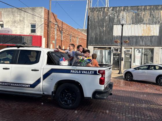 Parade participants throw water balloons at the crowd during Monday's Water Fight Parade. News Star Photo by Suzanne Mackey.