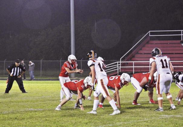 Maysville‘s Ryan Johnson awaits the snap of the ball in the game against Ryan Aug. 29. The Warriors lost the rainy Friday night game to the Cowboys, 46-0. News Star phooto by Chris Mackey