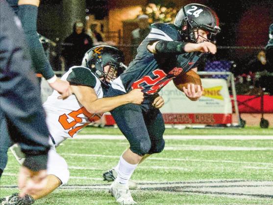 Leopard Owen Simonton tackles the Knights running back during the second round playoff game last Friday. Photo by Kristy Schrader