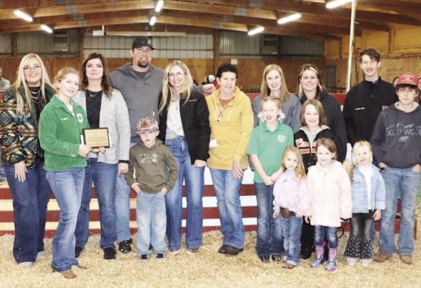 Family members of Dale and Toby Jones presented Maysville 4-H member Elise Beach (second from left) with the Give It Your All Award - In Memory of Dale and Toby Jones during Maysville's local livestock show in February. Courtesy photo