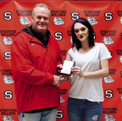 Abcde DeCarr (right) receives her December student of the month award from Principal Paul Savage.