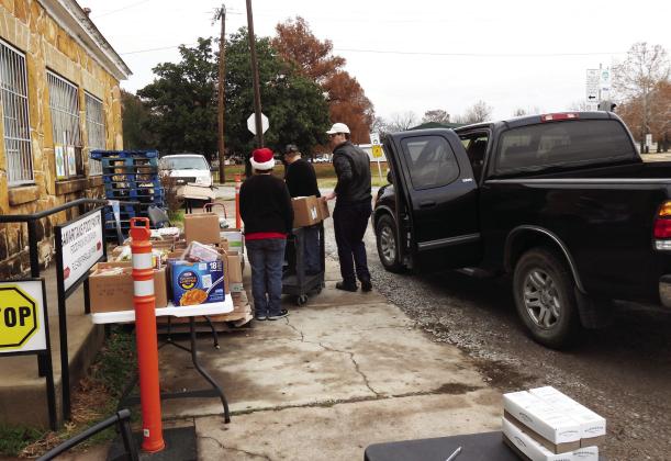 Community volunteers helped to distribute food boxes for Samaritans of Pauls Valley on Dec. 8. The food pantry served more than 380 households from Garvin County in December, with a food cost of more than $15,000. News Star Photo by Chris Mackey