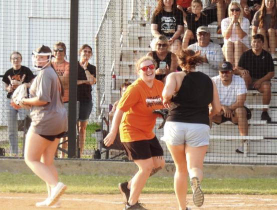 Lindsay's softball coach and class of 2015 alum Ellanee Moore (center) waits at home plate to tag out Leopardette alum Shana Allege, class of 2010, during Saturday evening's Alumni Softball Game. Alumni from even-numbered years dominated the team from odd-numbered years in a 12-4 win. News Star photo by Chris Mackey