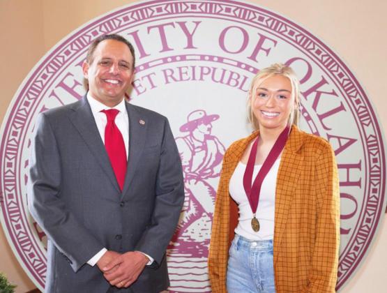 Claire Kendall, Pauls Valley, is one of 56 students set to graduate from OU in December who were recently honored for maintaining a perfect 4.0 grade-point throughout their undergraduate studies. Kendall is pictured with OU President Joseph Harroz Jr.