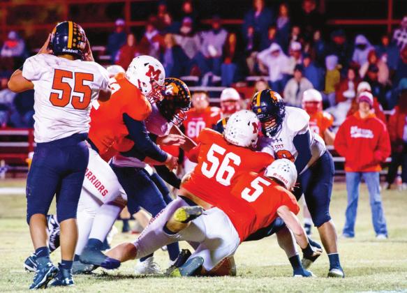 Maysville's Benson Larson, Kolby Wyatt and Nigel Reid work together to tackle the Boise City running back during last Friday’s game. Photos by Kristy Schrader