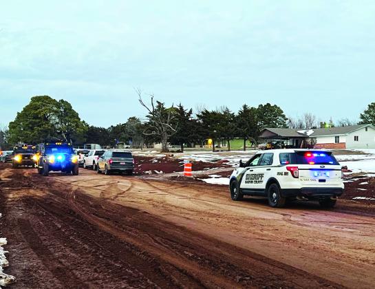 Investigators from multiple law enforcement agencies worked Friday evening to process the scene of a pipe bomb detonation that killed a man during a standoff with police at a residence north of Pauls Valley. Garvin County News Star photo by Jennifer Lindsey
