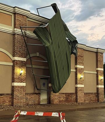 Tuesday’s storms left this carport perched precariously on the front of the Pauls Valley Police Department. The structure was originally located in a fenced area on the PVPD property, adjacent to the building. News Star photo by Suzanne Mackey