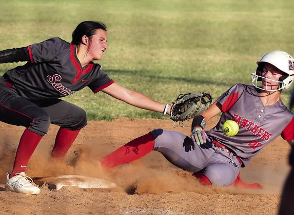 Pauls Valley’s Raegan Close takes a ball off the gut as she slides into third during action with Wynnewood Monday in the Wayne Festival. Photo by Mike Arie