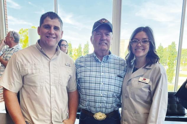 Aubry Hensley-Gollihare (right) with her grandfather, Dr. Gerald Parsons (center), and husband, Jacob Gollihare (left), at Friday's gray-coat induction ceremony for Oklahoma State University's College of Veterinary Medicine Class of 2026.