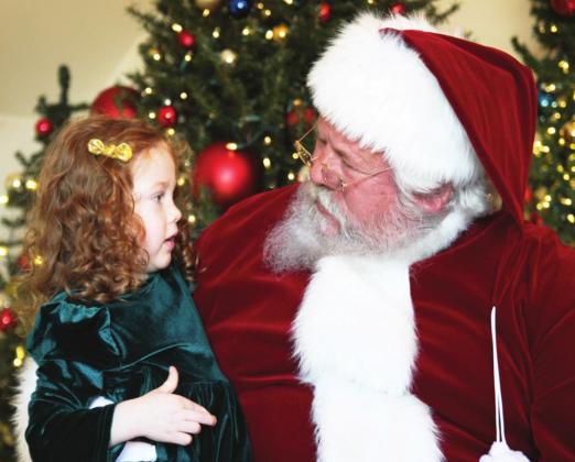 Little Miss Johnson had a heart to heart talk with Santa during her visit to the Murray-Lindsay Mansion for the Lindsay Community Historical Society's Christmas Fundraiser on Dec. 5. Photo courtesy of Sheryl Kochert