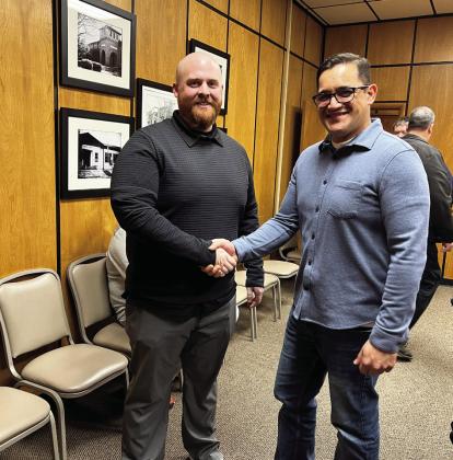 Pauls Valley Board of Education President Jesse Alvarado (right) congratulates Mason Anthony (left) after Wednesday's board meeting in which Anthony was named as the district's new head football coach.