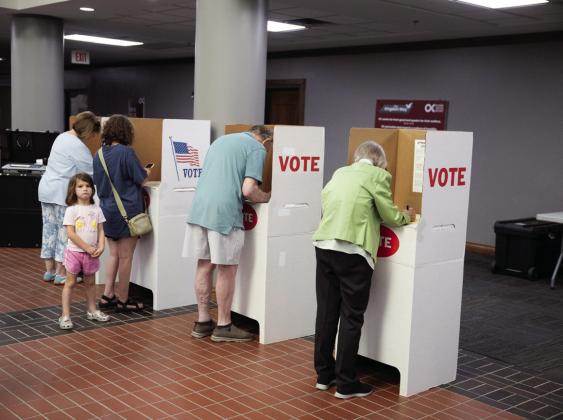 Some voters refer to their cell phones while casting ballots at Oklahoma Christian University in Edmond on June 16, 2026. Brent Fuchs/Oklahoma Watch