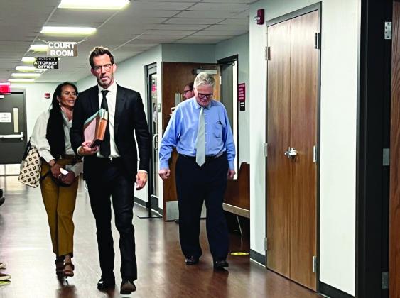 Dr. Edward Hallowell (far right) walks out of a Garvin County courtroom Wednesday with his attorney Josh T. Welch after being arraigned on three felony counts. News Star photo by Suzanne Mackey