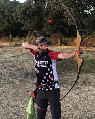 Shiloh Butts takes aim at a target in his USA team uniform. Photo courtesy of Chickasaw Nation.