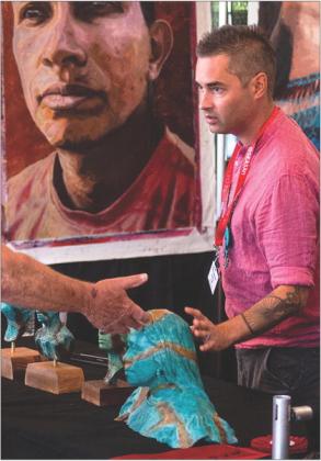 National and internationally acclaimed Chickasaw artist Addison Karl visits with a patron during the 2022 Southeastern Arts Show and Market (SEASAM). SEASAM is set to begin Oct. 6 during the Chickasaw Annual Meeting and Festival.