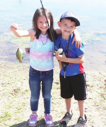 Two young anglers proudly show off their big catch during Saturday's Fishing with Firemen in Stratford. Around 50 youth turned out to fish at the event hosted by the Stratford Fire Department and the Oklahoma Department of Wildlife. 