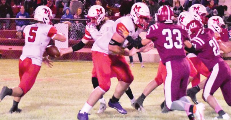 Bo Green hands the ball off to Nigel Reid during last Friday night’s game against Mt. View-Gotebo. 