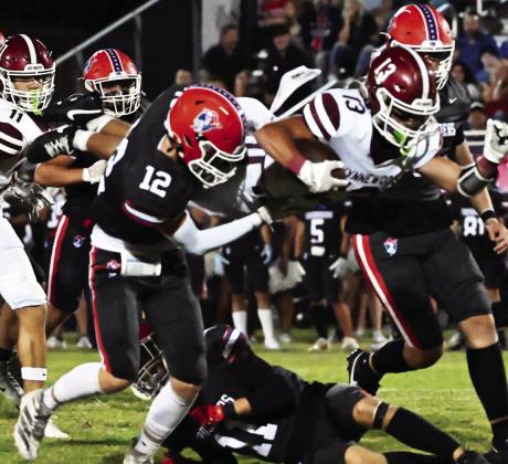 Wynnewood’s #13 Briar Davenport goes airborn for extra yards as #11 Phoenix Sparks runs in to help in Wynnewood’s 30-7 win over Christian Heritage Oct. 3. News Star photo by Don Coffey