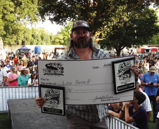 Levi Bennett won the top prize of Biggest Fish at Pauls Valley’s Okie Noodling Tournament Saturday. Bennett placed first in the tournament’s Scuba Division with a fish weighing in at 74.29 pounds. News Star photo by Chris Mackey